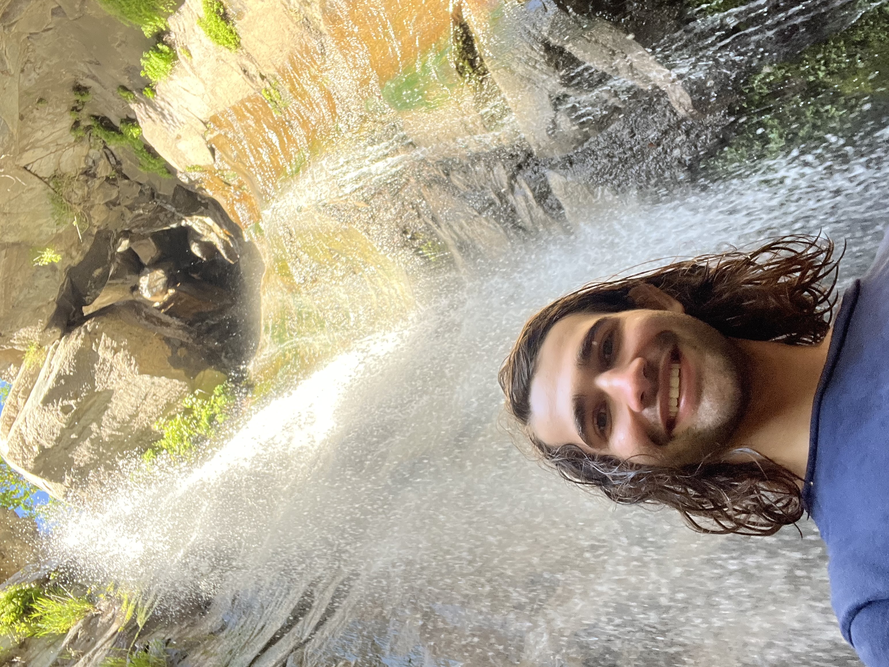 Nathan Derhake in front of a waterfall